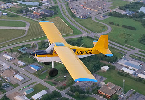 photo of a yellow old-fashioned small airplane